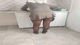 Turkish woman in hijab is cleaning the kitchen in the village house