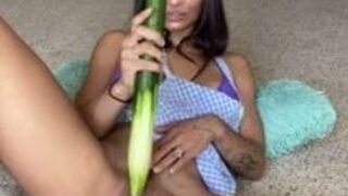 Crazy girl using a cucumber