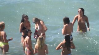 bikini girls are topless on the sea