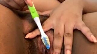horny african chick masturbating juicy snatch with toothbrush