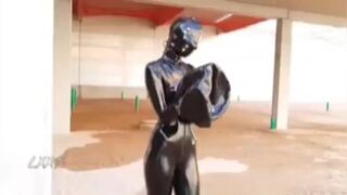 Red Haired Slut in Latex Wears three Layers of Masks